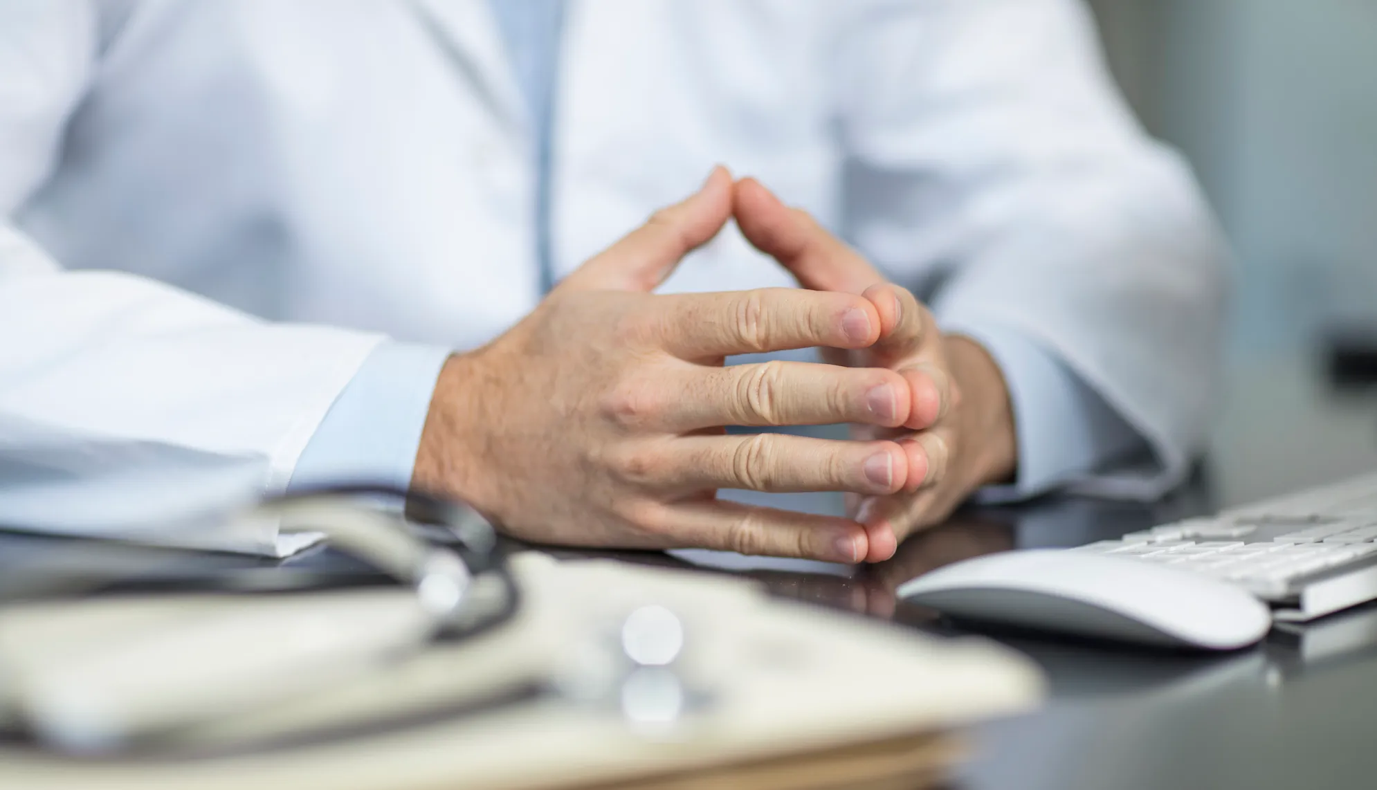 Doctor sitting at desk and his files