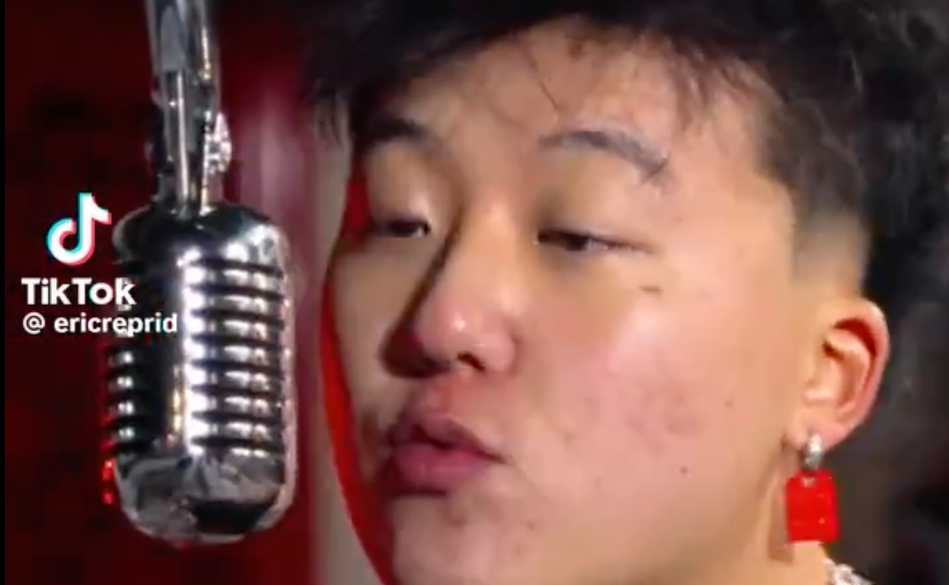 Image shows Canadian Rapper Eric Reprid singing into a microphone