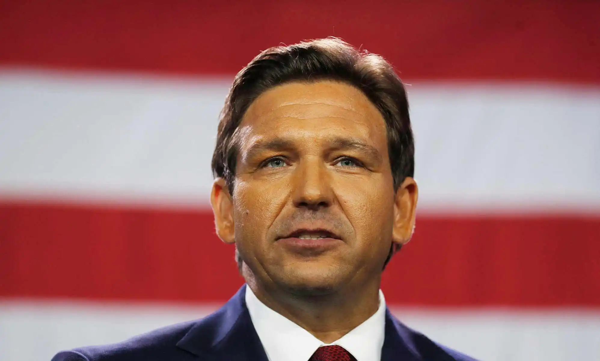 Florida governor Ron DeSantis in front of a US flag
