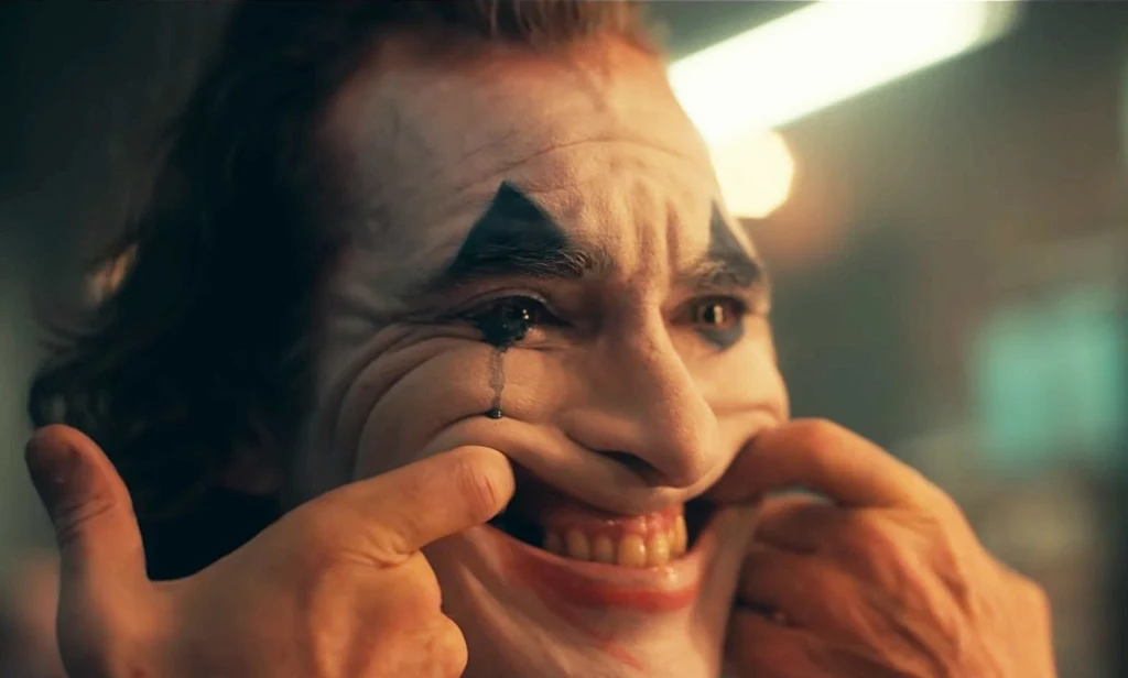 The Joker forcing himself to smile but crying