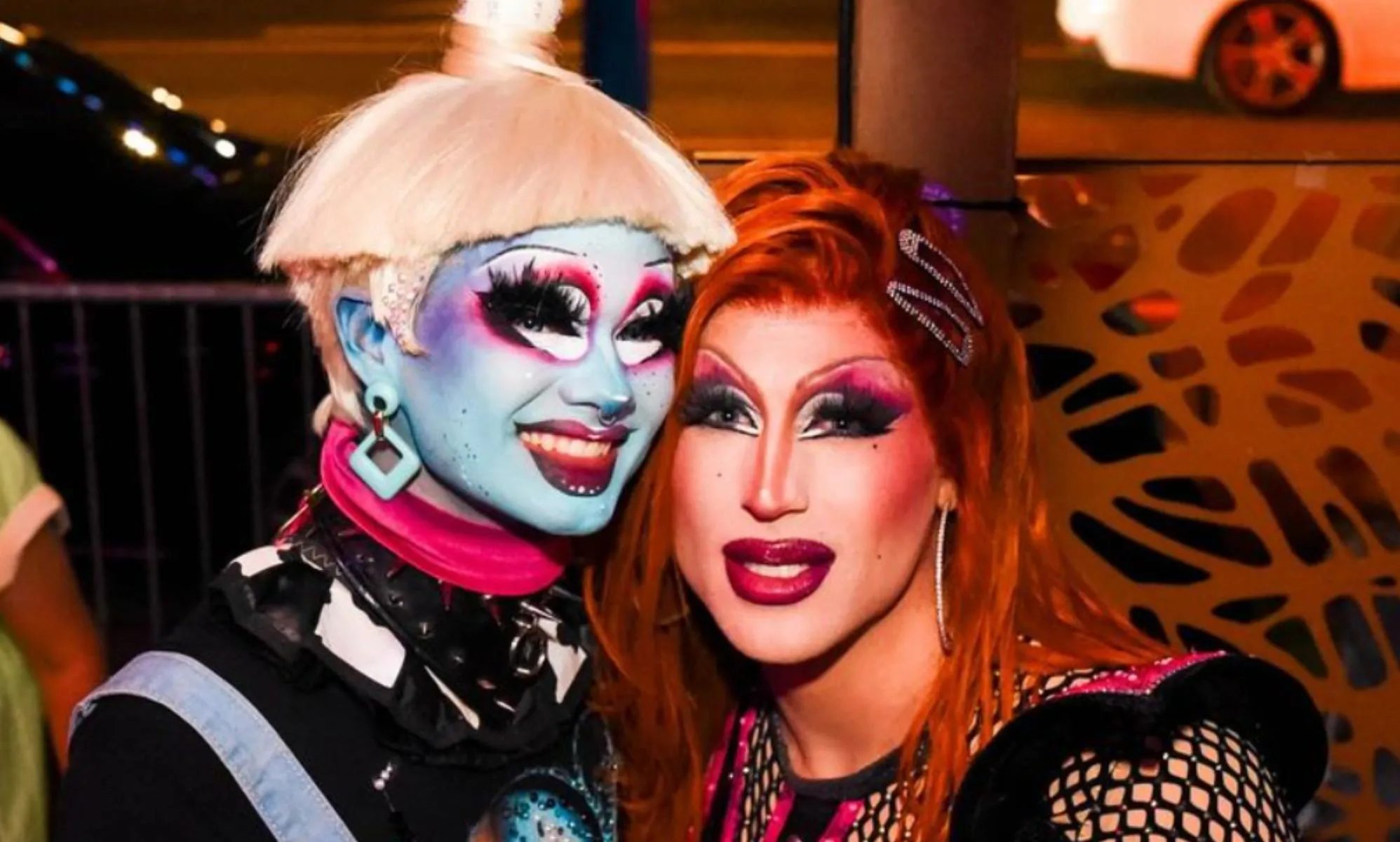 A photo of Drag Race season 16 contestants Dawn and Amanda Tori Meating in drag smiling.