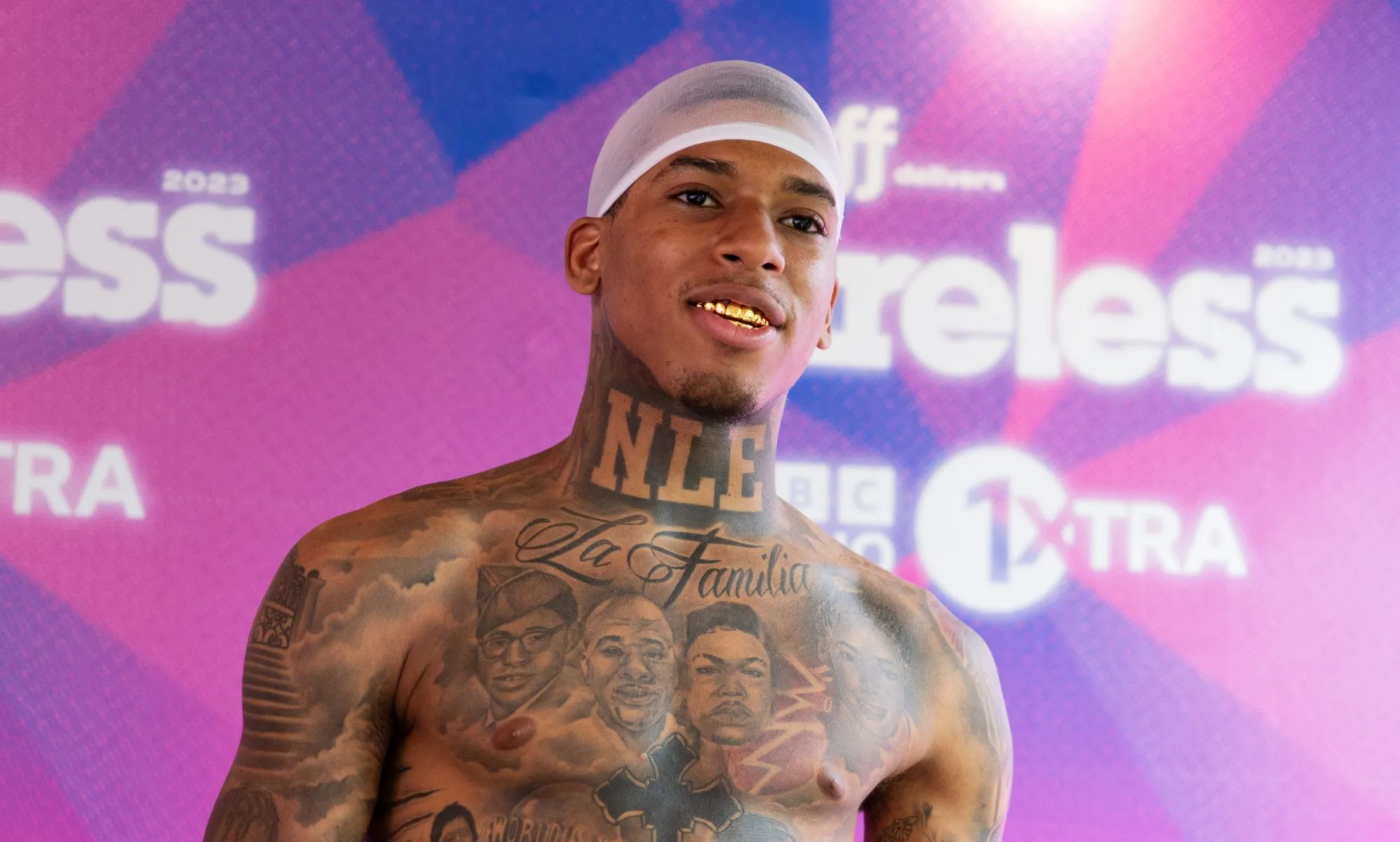 Rapper NLE Choppa smiles while topless at Wireless festival.