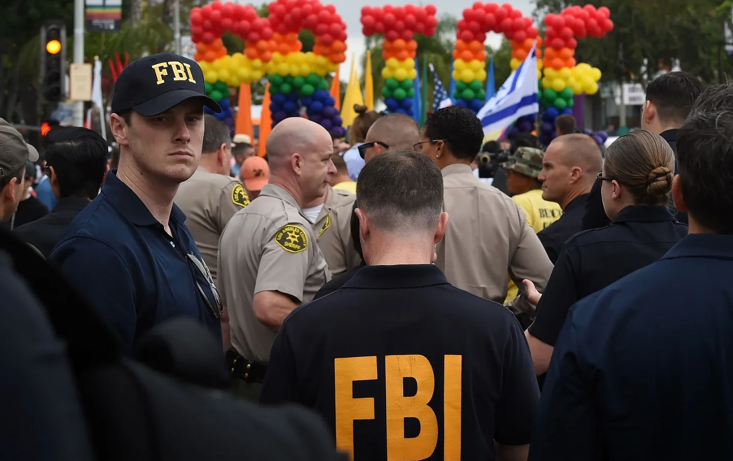 FBI agents keep watch during the 2016 Gay Pride Parade in West Hollywood, California on June 12, 2016.