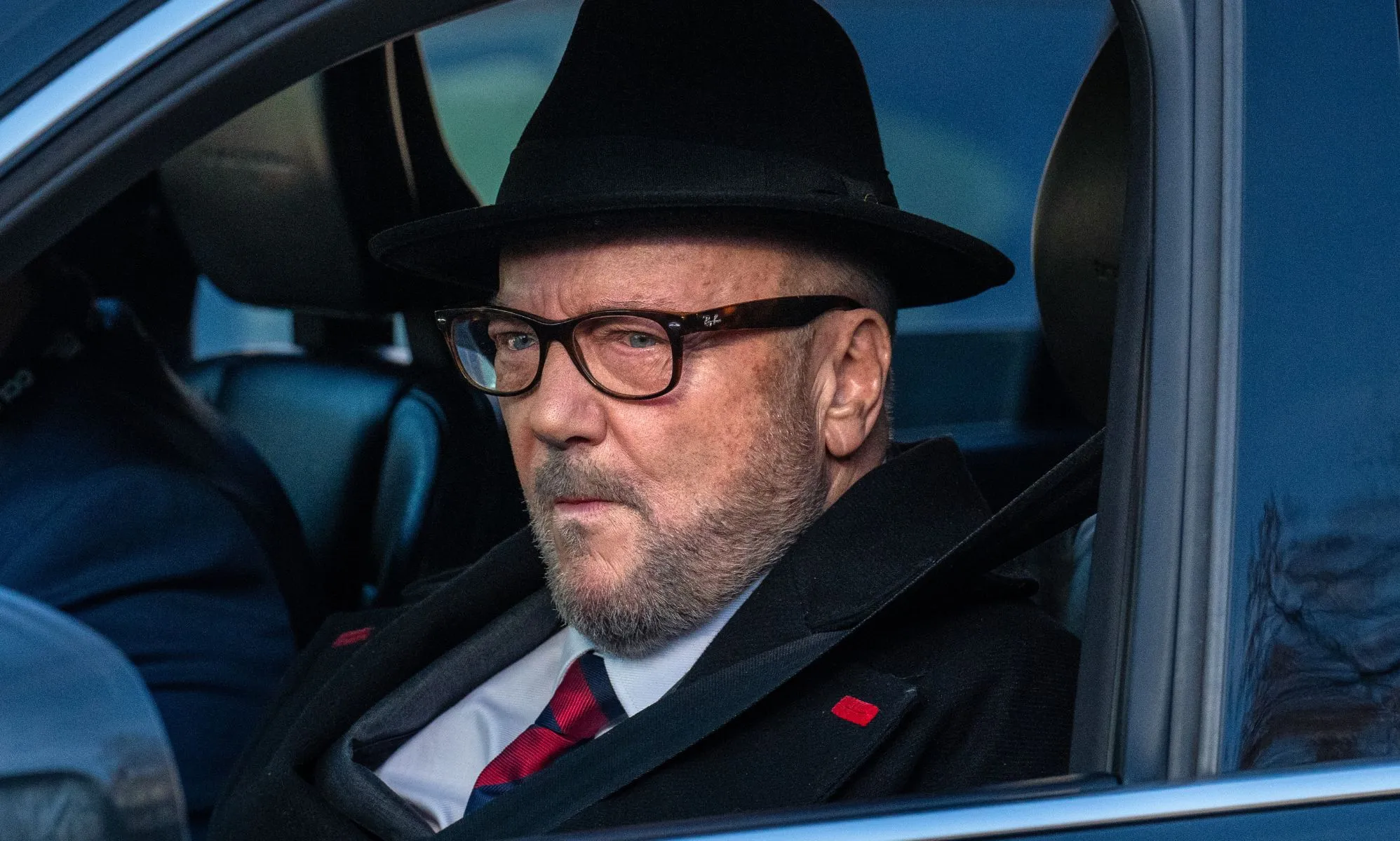 George Galloway in a car.