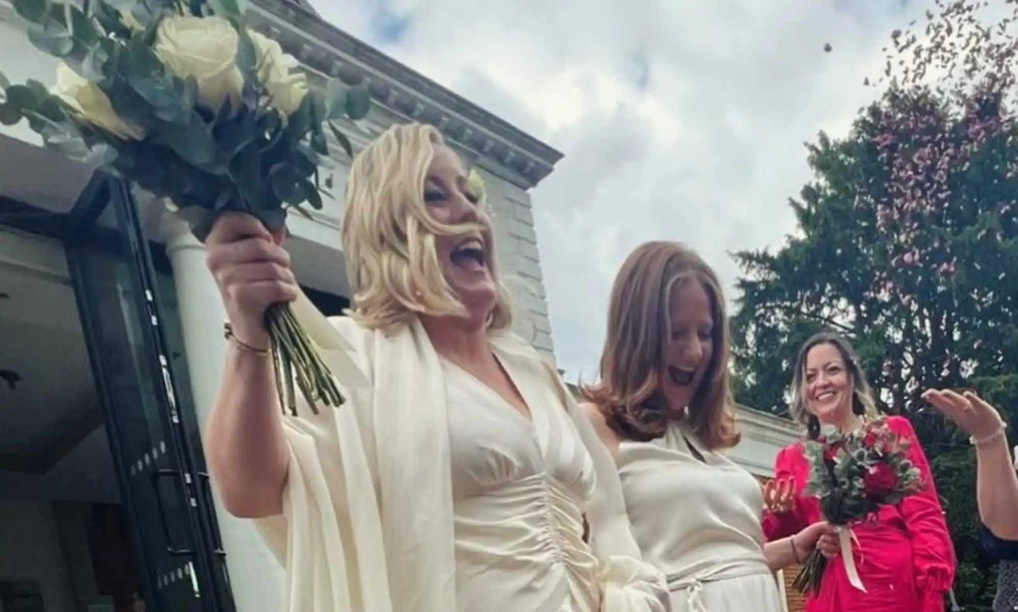 Hannah Bardell and wife Lucie in their wedding dresses