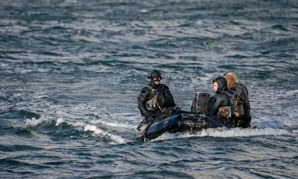 3 navy seals sitting in a boat