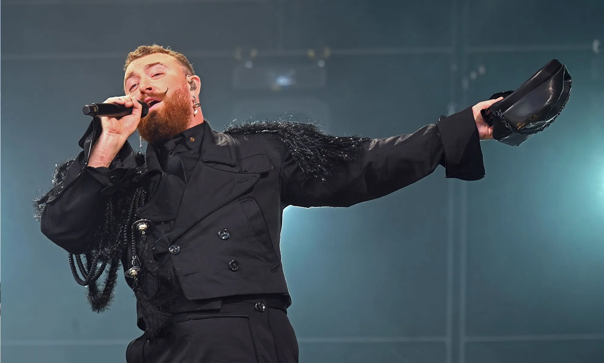 Sam Smith performing in an all-black outfit in the Netherlands
