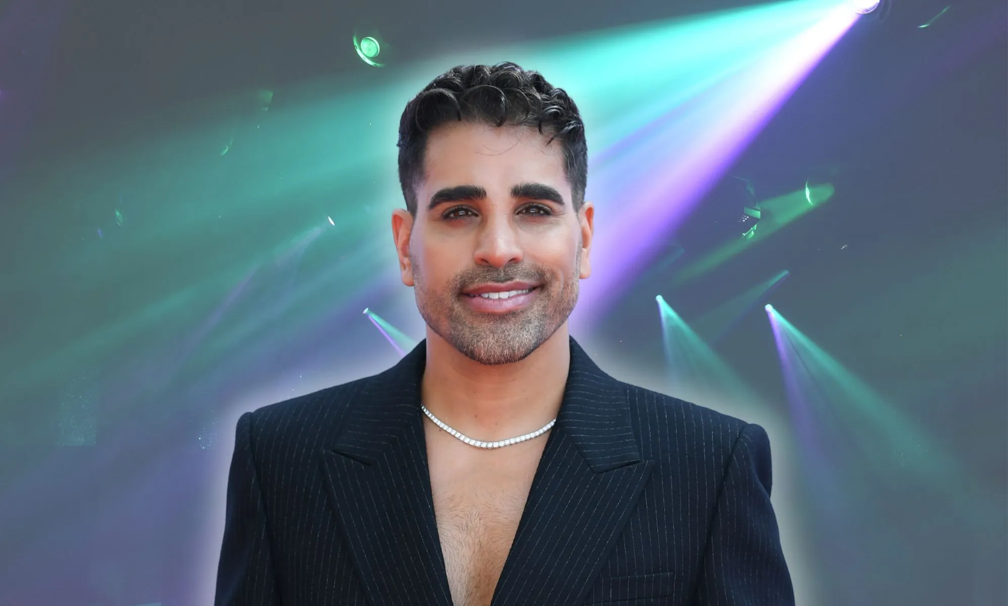 Dr Ranj Singh against purple and blue spotlights