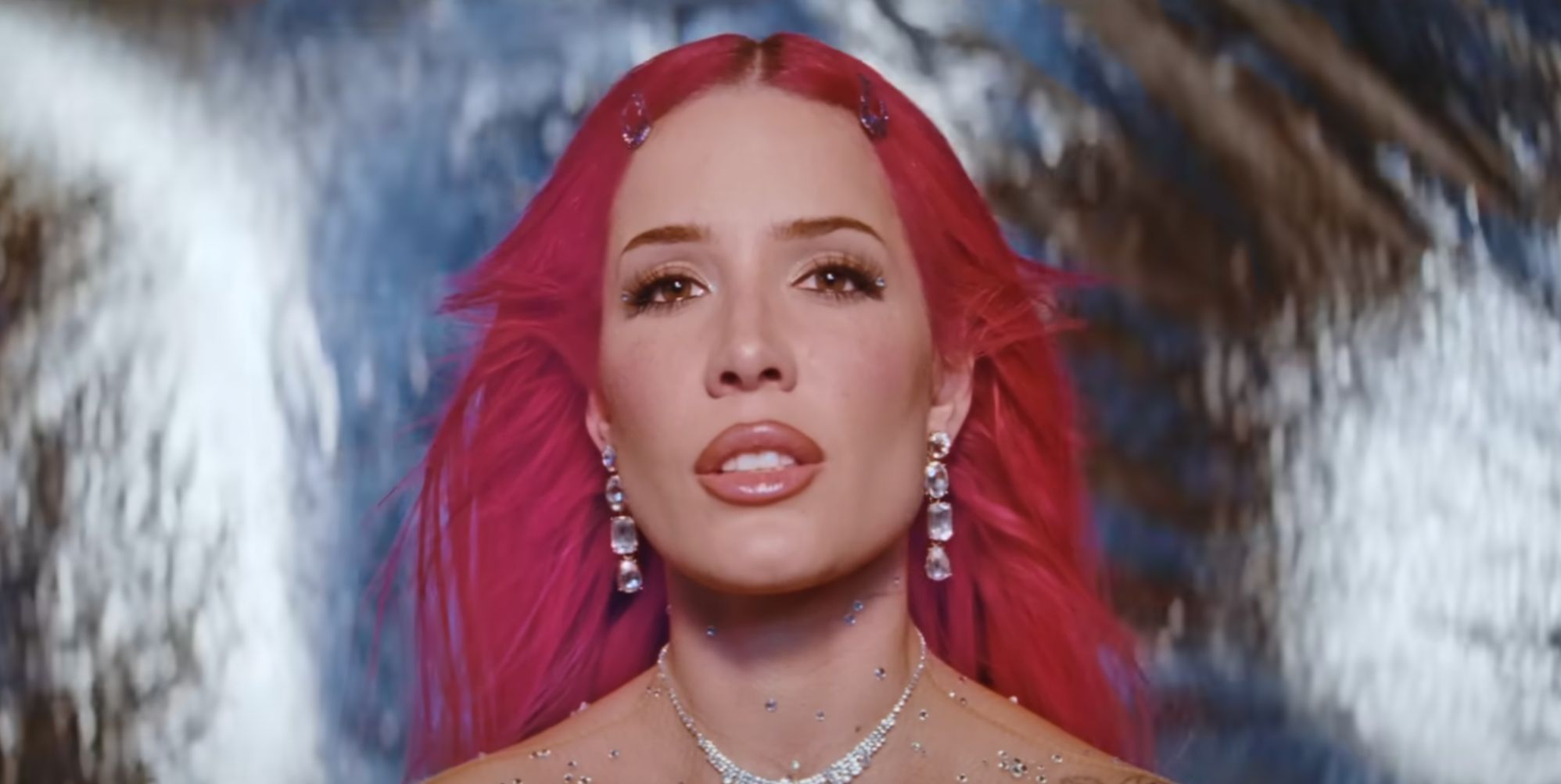 Halsey in a pink wig in a still from her new single Lucky.