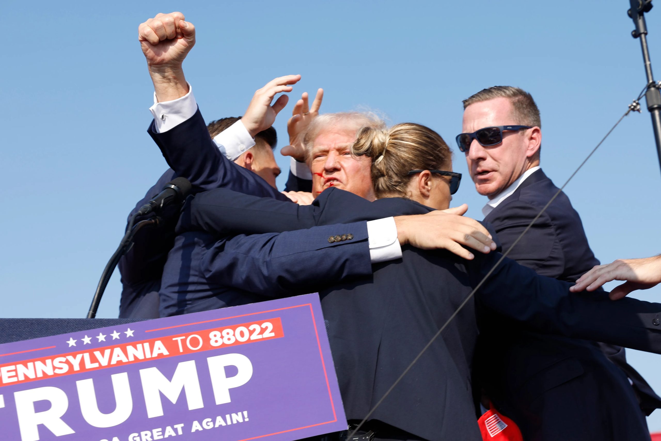 Donald Trump being saved by secret service after shots rang out at his campaign rally by shooter Thomas Matthew Crooks