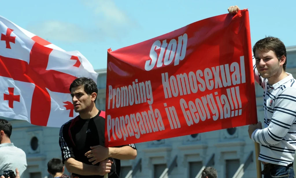 Two men holding up a sign that reads