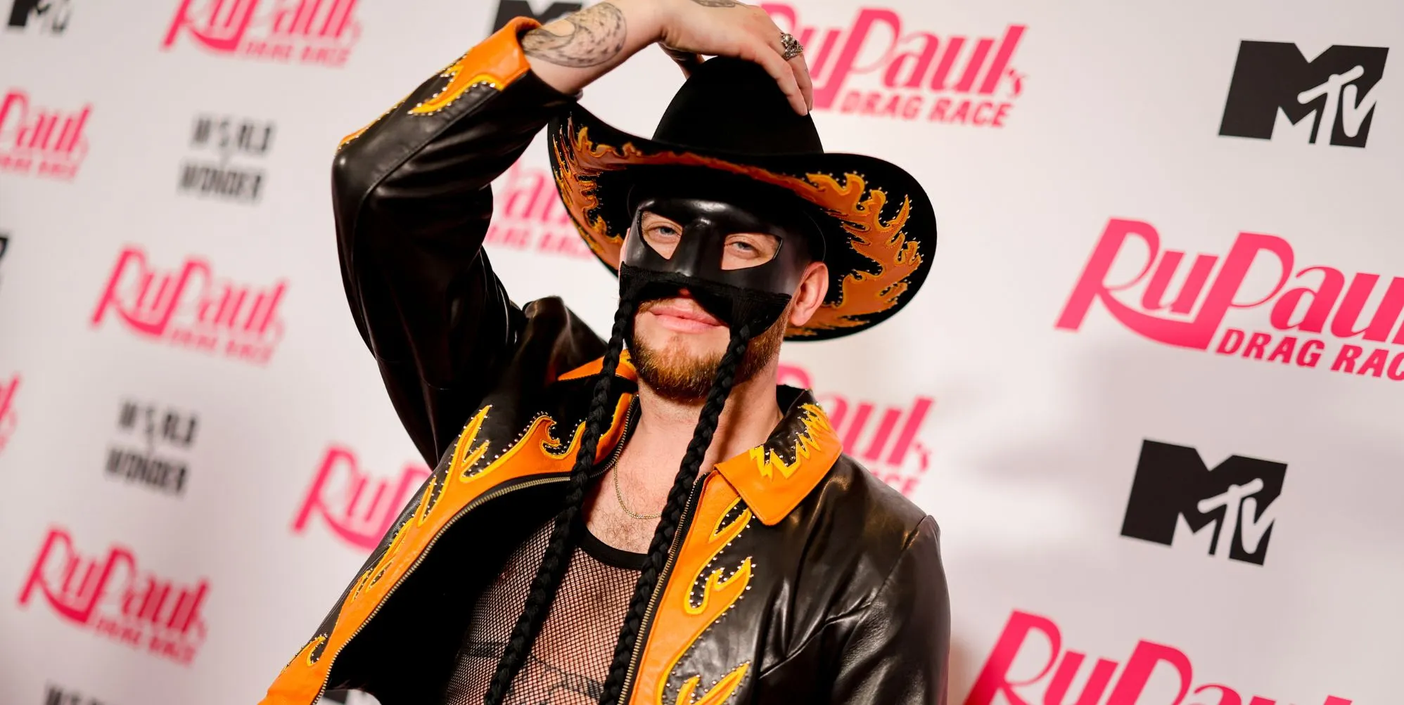 Orville Peck holds his cowboy hat.