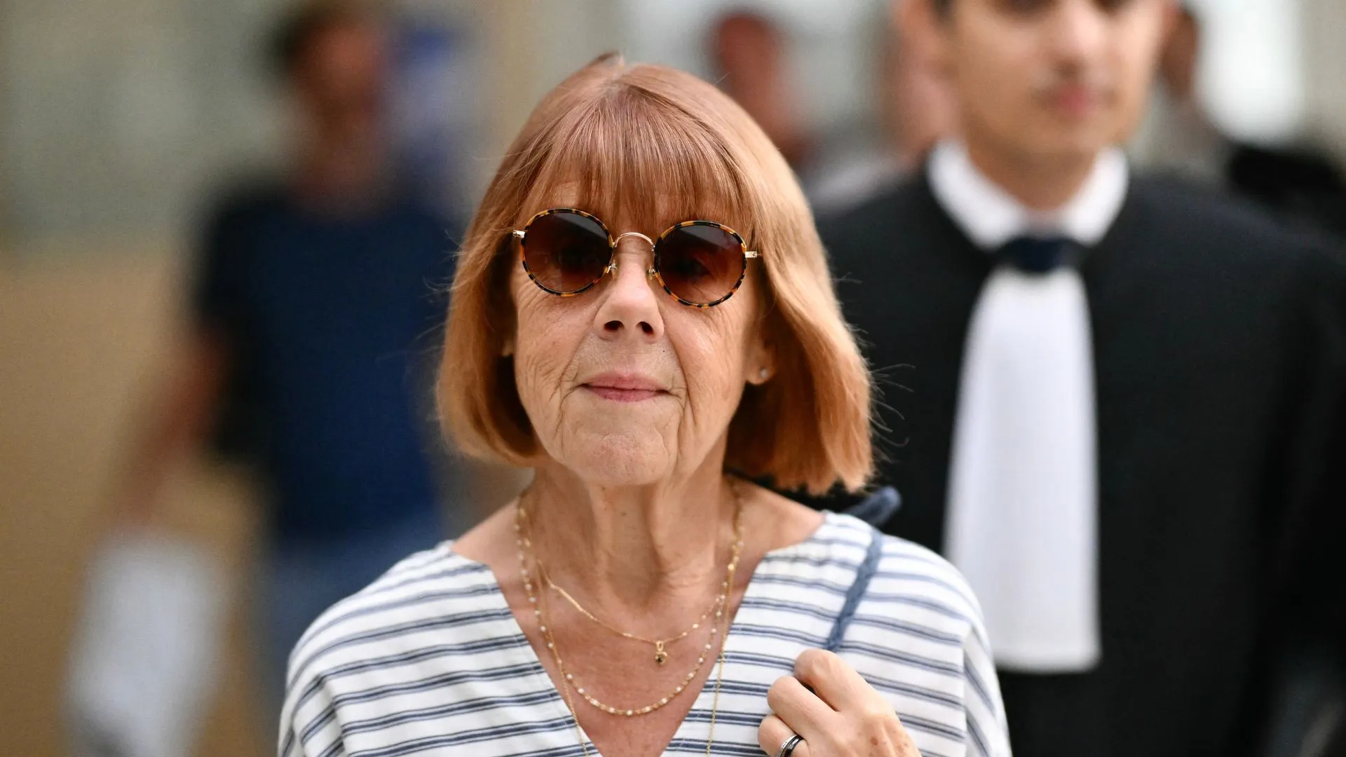 Gisèle Pelicot arrives at the Avignon courthouse, flanked by her lawyer Stephane Babonneau (R), to attend the trial of her former partner Dominique Pelicot, accused of drugging her for nearly ten years and inviting strangers to rape her at their home in Mazan, a small town in the south of France, in Avignon, on September 10, 2024