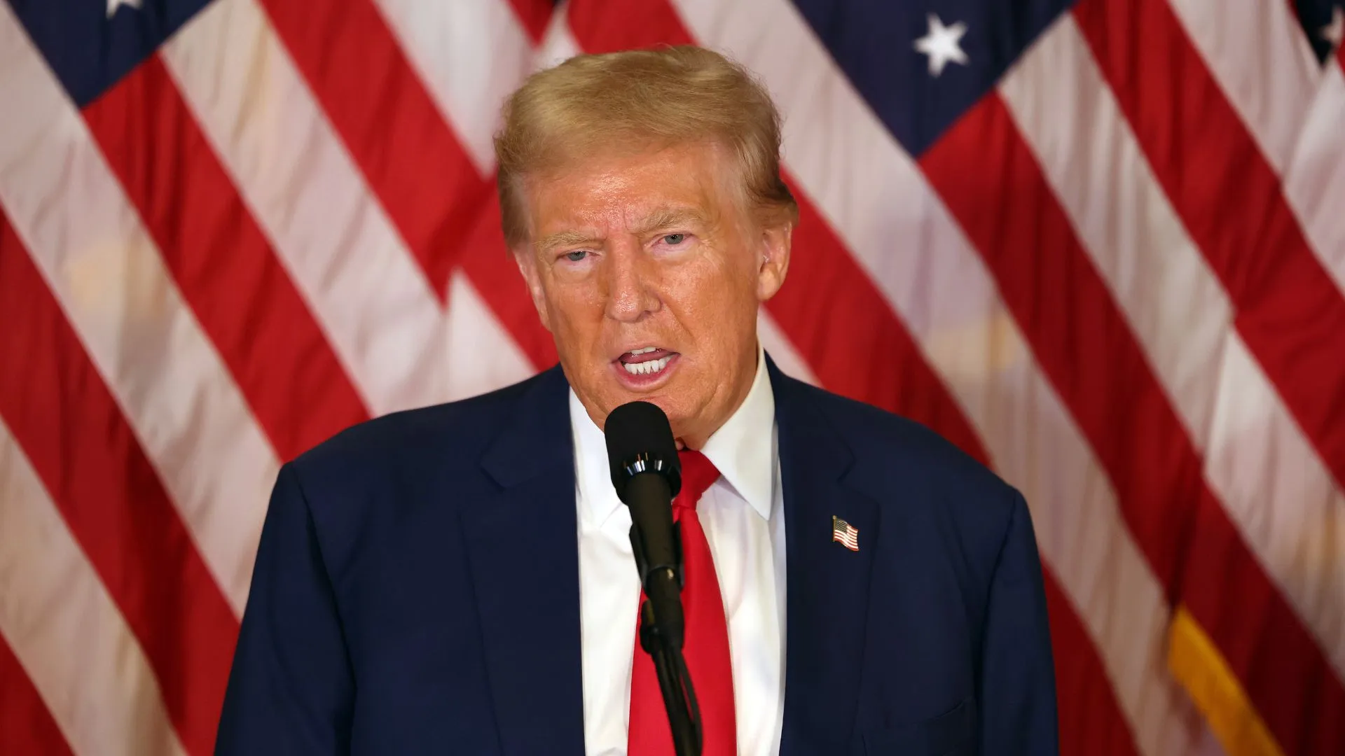 Photo of Donald Trump standing in front of an American flag