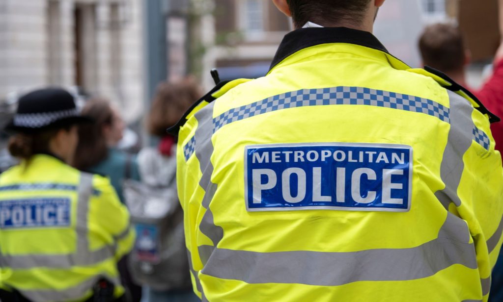 A picture of the back of the yellow and blue high vis jacket of a Metropolitan Police officer in London amid a rise in homophobic and transphobic hate crime in the UK