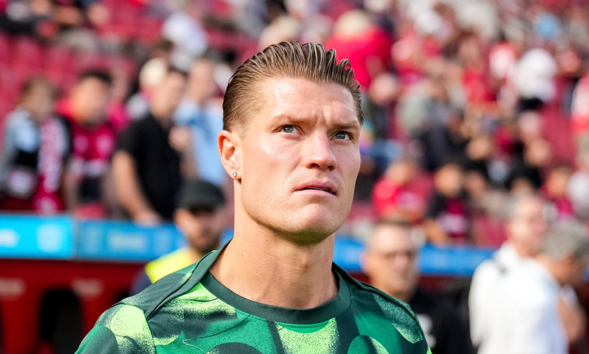 Kevin Behrens of VfL Wolfsburg walks out to warm up at a football match