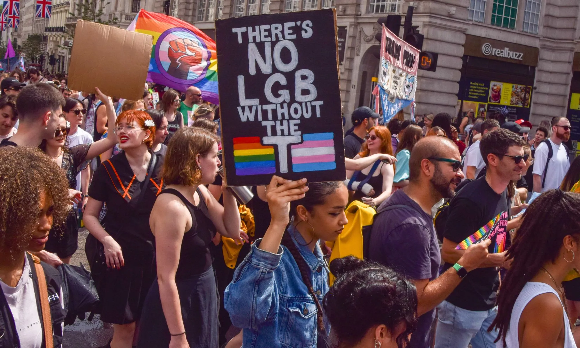 A protestor holds a sign reading "There