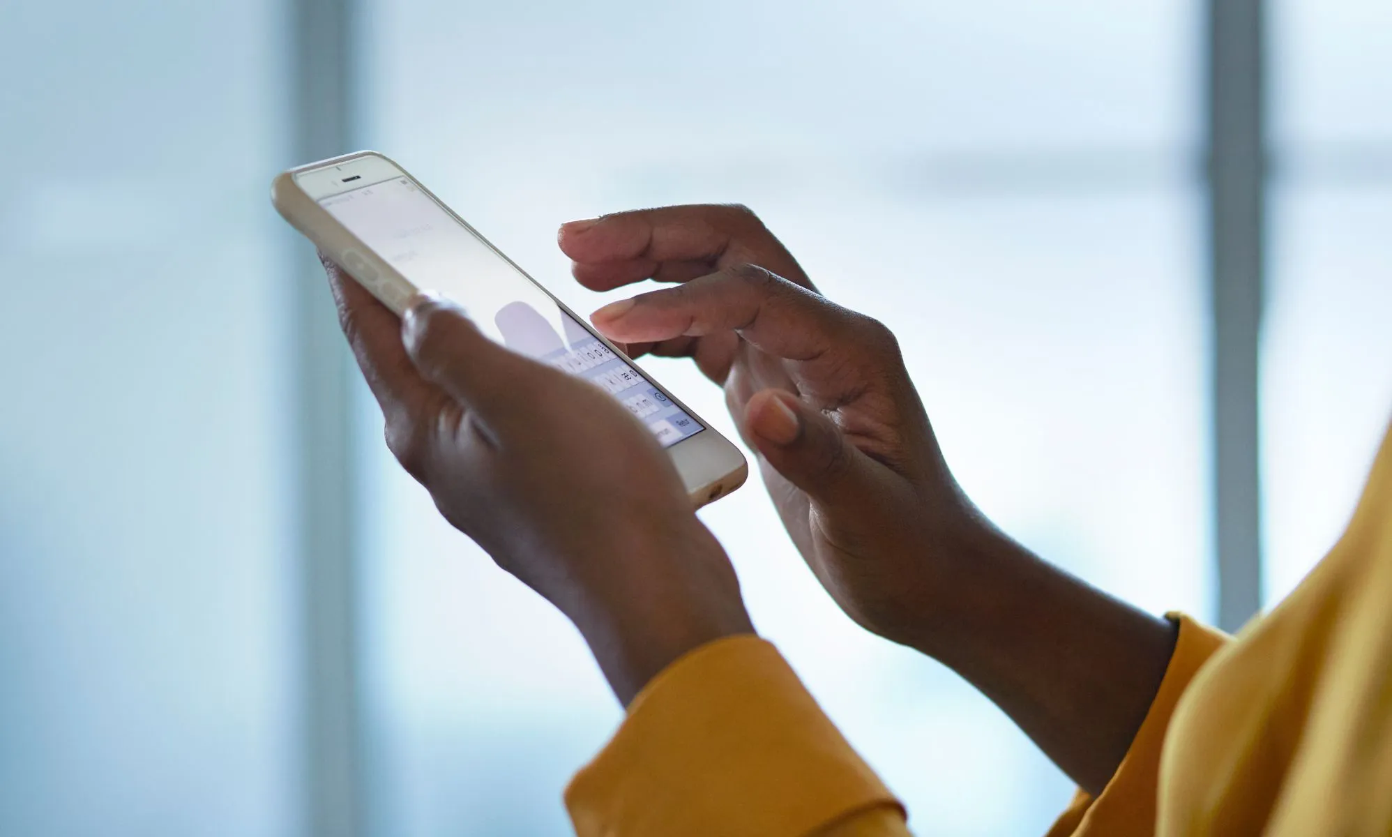 A person scrolls through their phone.