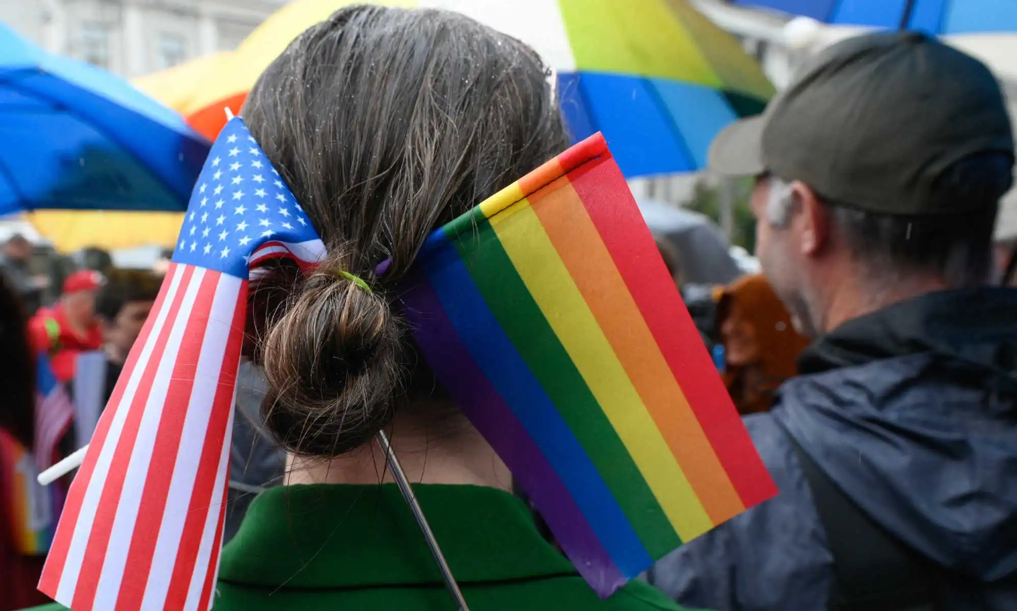 A Parade participant wears a US and LGBT flags in her hair.