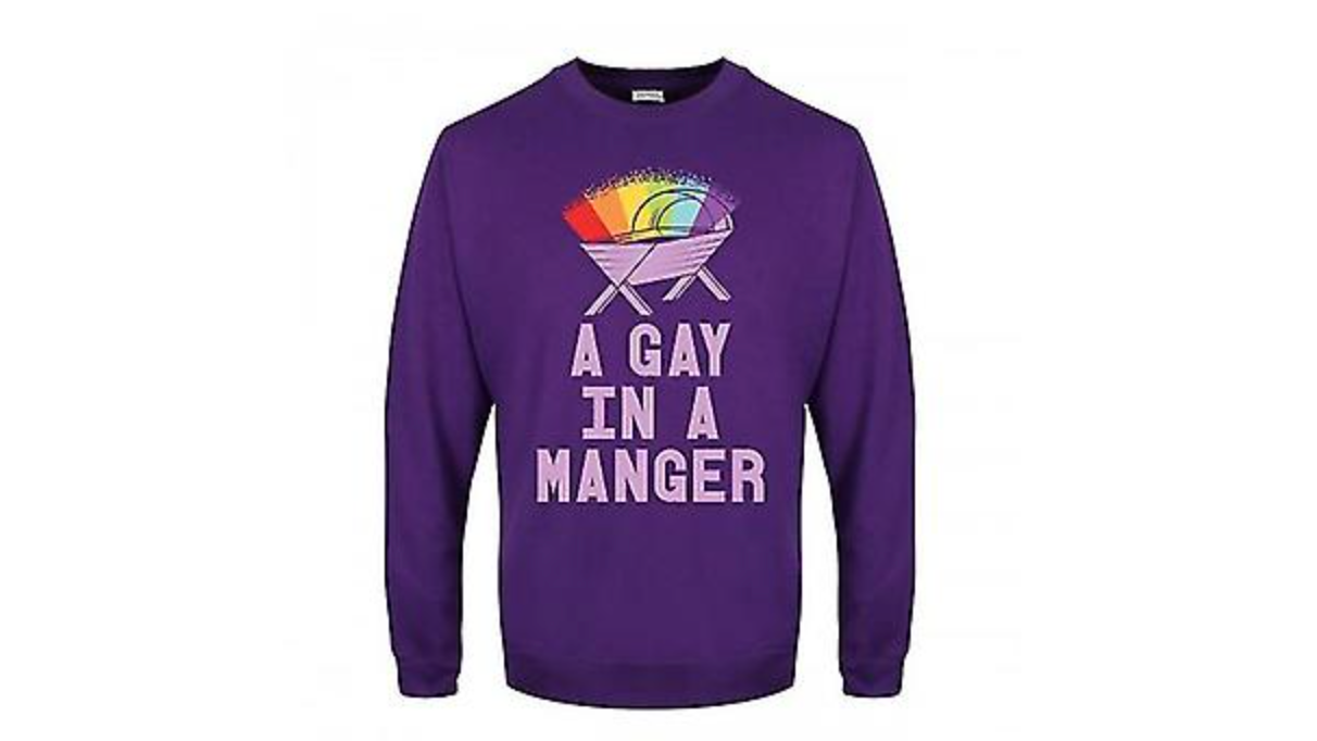 A purple Christmas jumper with a rainbow over a crib and the text