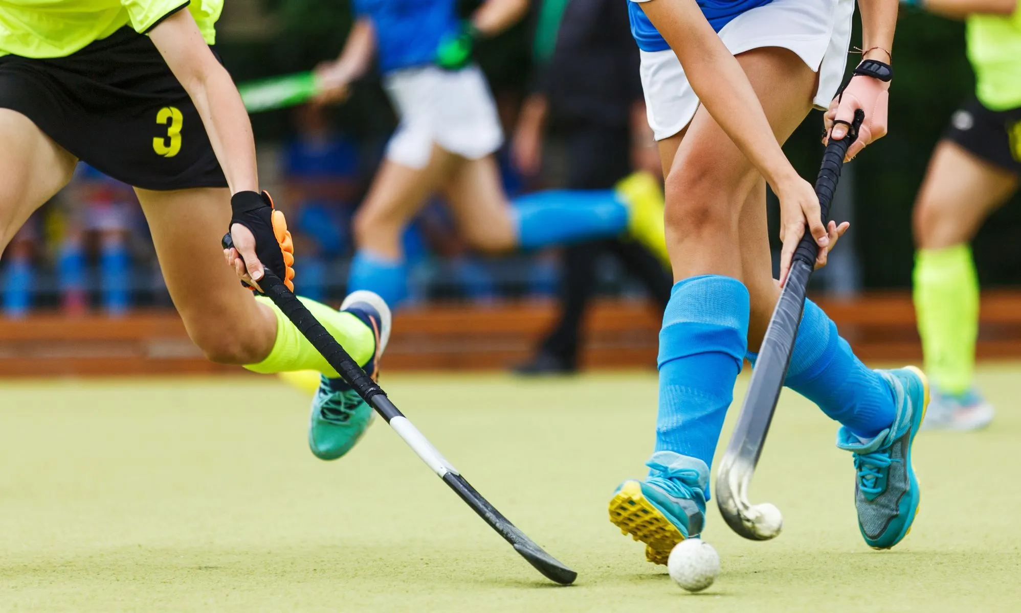 A close-up of a field hockey game.