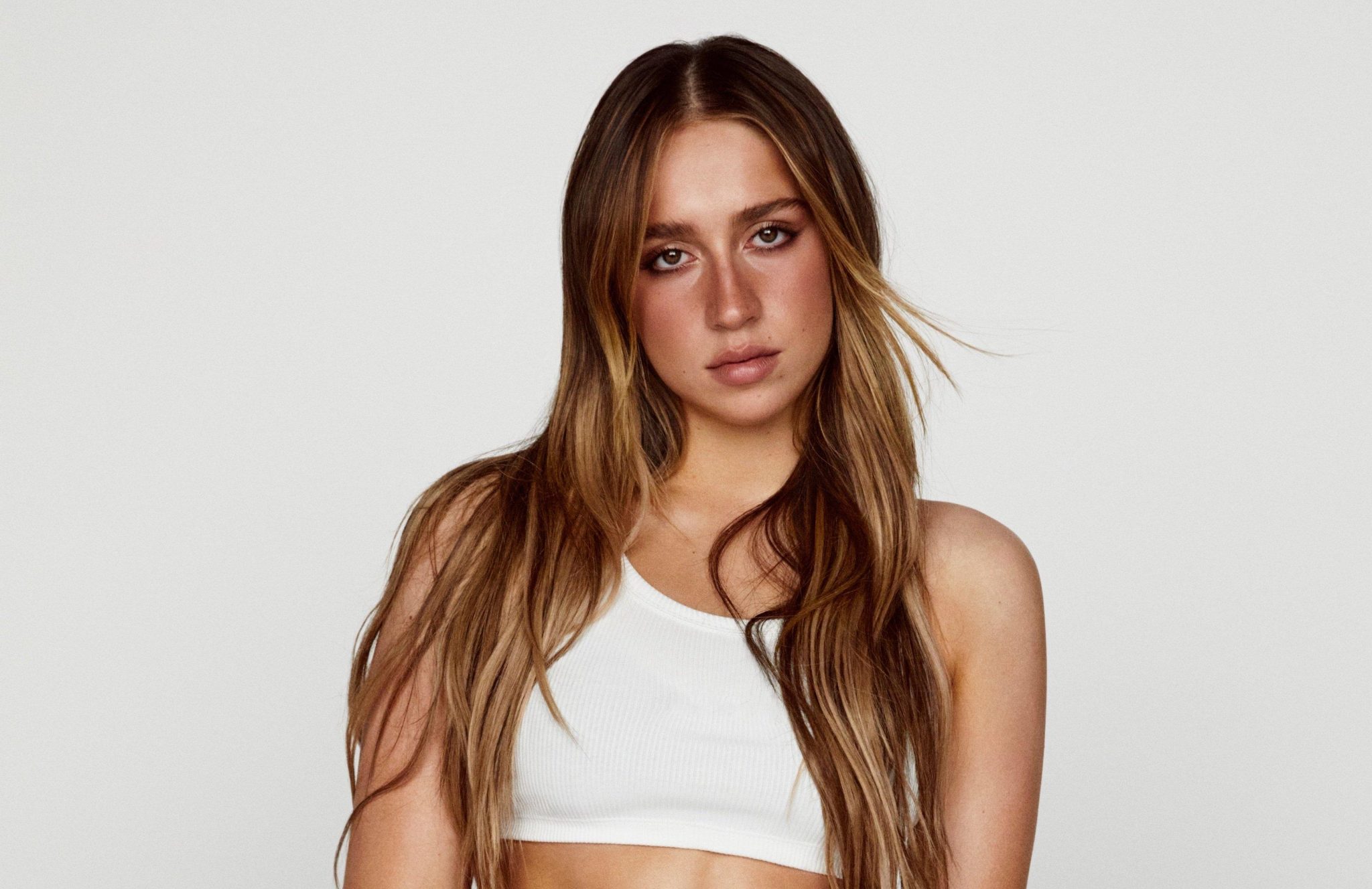 Rising pop star Tate McRae is opening up about her strong bond with her LGBTQ+ fans, admitting they are her