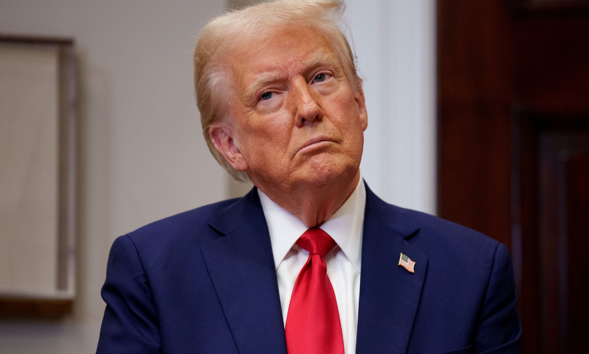 Donald Trump with his head tilted.