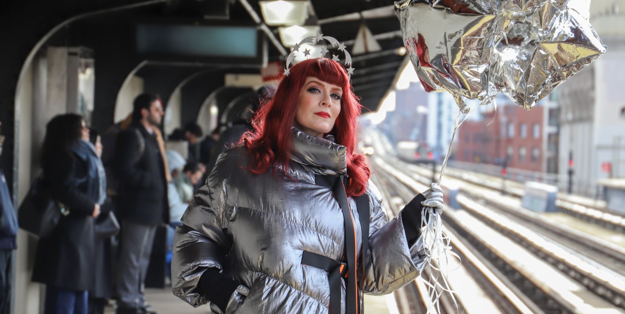 Ana Matronic at a train station holding a balloon