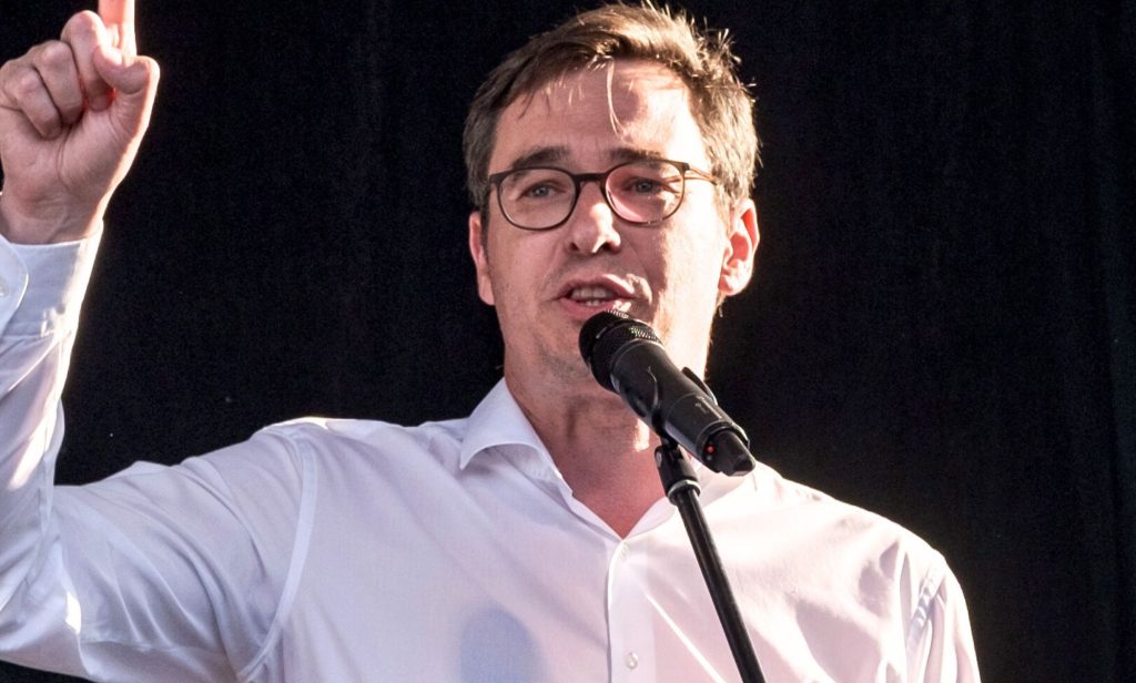 Gergely Karácsony, pictured pointing and speaking into a microphone.