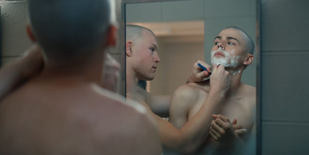 Miles Heizer shaves as a military recruit in Netflix show BOOTS.