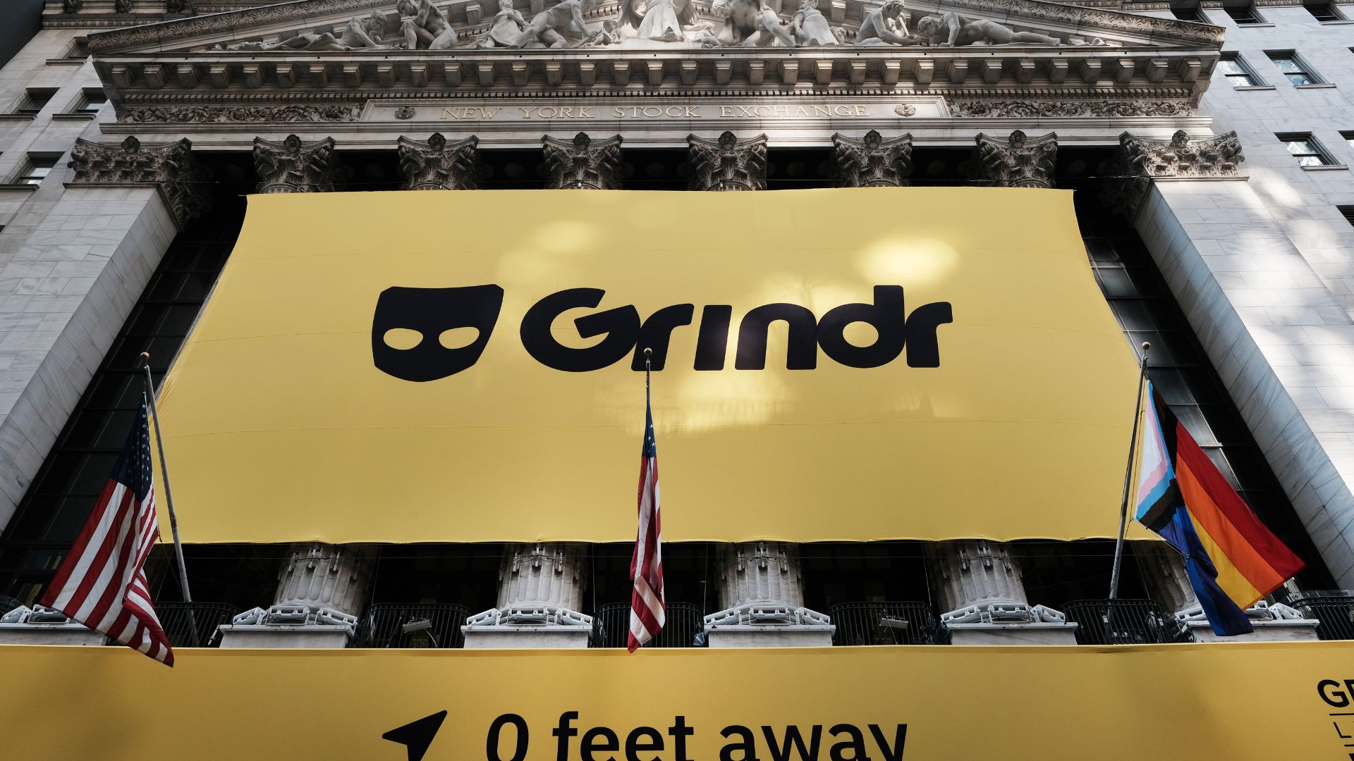 Grindr logo seen in a banner above the New York Stock Exchange