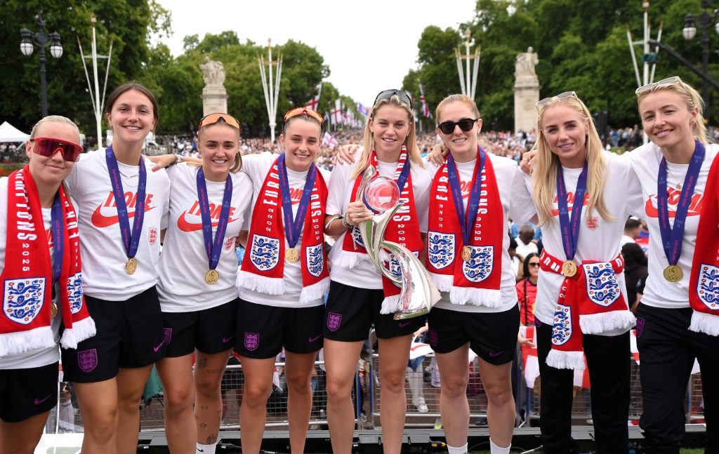 Beth Mead, Lotte Wubben-Moy, Georgia Stanway, Ella Toone, Alessia Russo, Keira Walsh, Alex Greenwood and Leah Williamson of England pose for a photo on stage with the UEFA Women