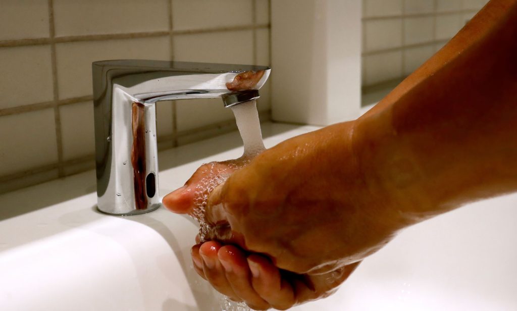 An unpictured person washing their hands.