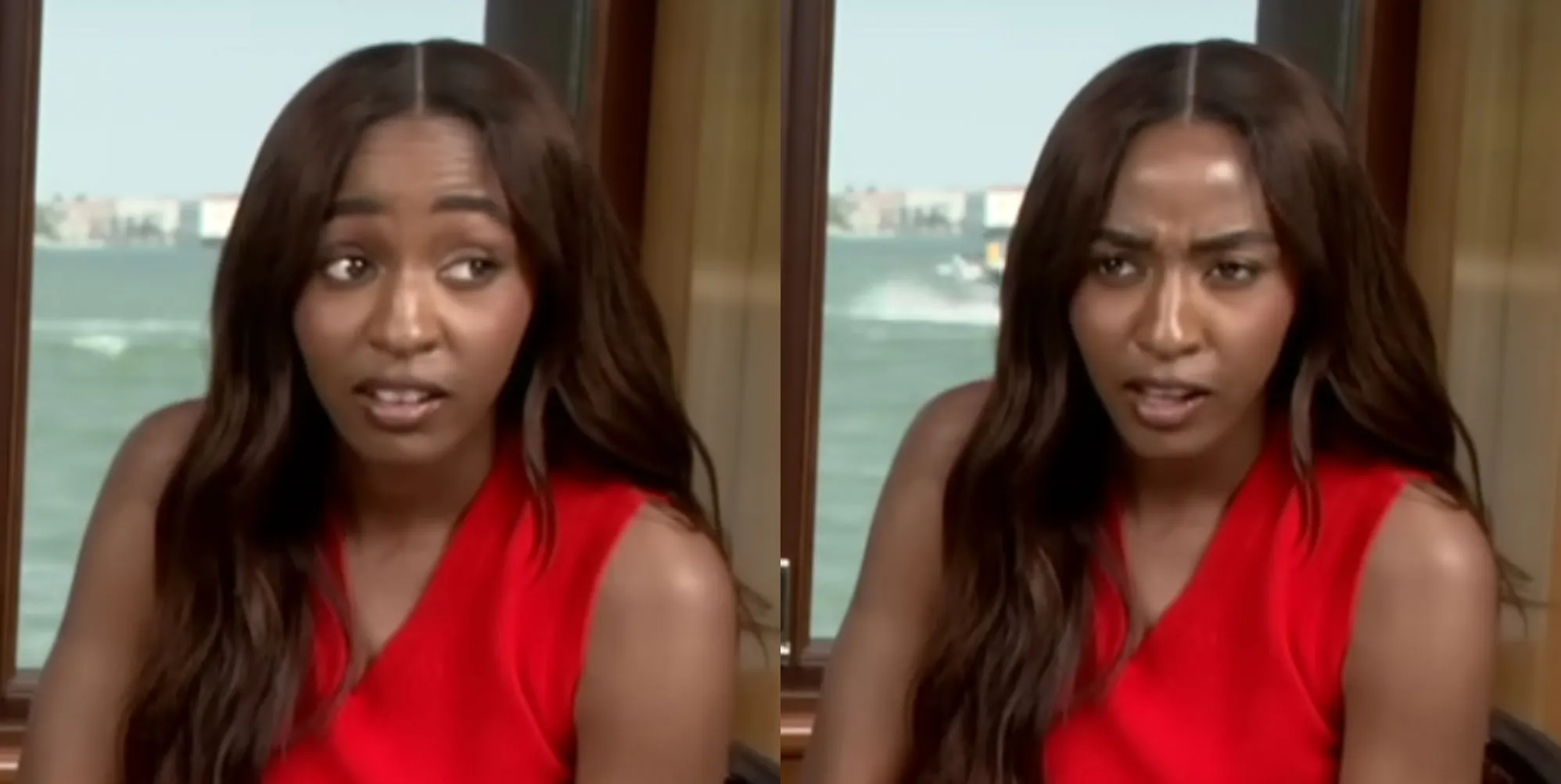 Ayo Edebiri looking shocked in a press junket. She is wearing a red top with her hair over her right shoulder.