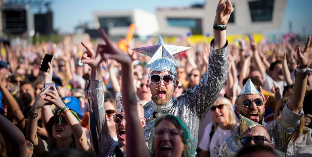 Eurovision fans enjoy the party atmosphere as they gather in Liverpool to watch the Eurovision Song Contest final on a giant screen in the Eurovision Village on May 13, 2023