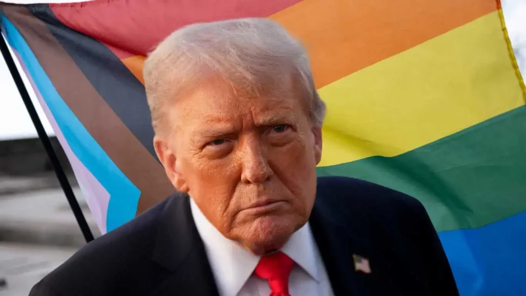 Donald Trump stands in front of Progress Pride flag.