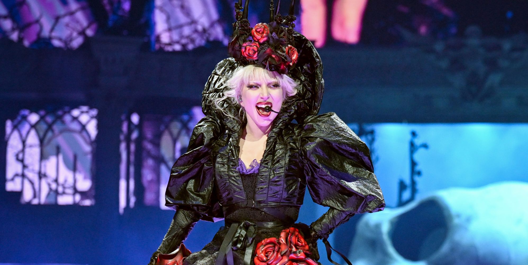 Lady Gaga smiles as she performs at the Mayhem Ball in London.