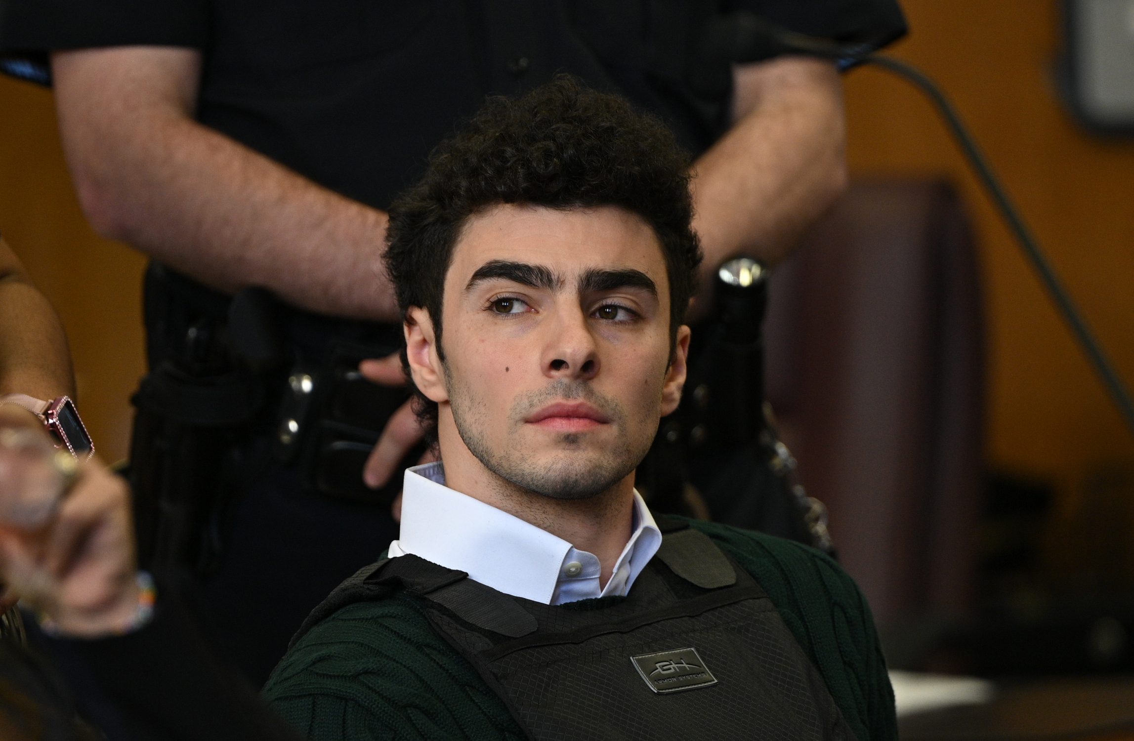 NEW YORK, NEW YORK - FEBRUARY 21: Luigi Mangione appears at a hearing for the murder of UHC CEO Brian Thompson at Manhattan Criminal Court on February 21, 2025 in New York City. Mangione is accused of slaying of UnitedHealthcare CEO Brian Thompson late last year and is making his first appearance on state charges of murder as an act of terrorism. He is facing 11 counts for the Dec. 4 shooting of Thompson outside a midtown Manhattan hotel which set off a massive manhunt. He is also facing federal charges of murder and other charges in Pennsylvania, where he was arrested.