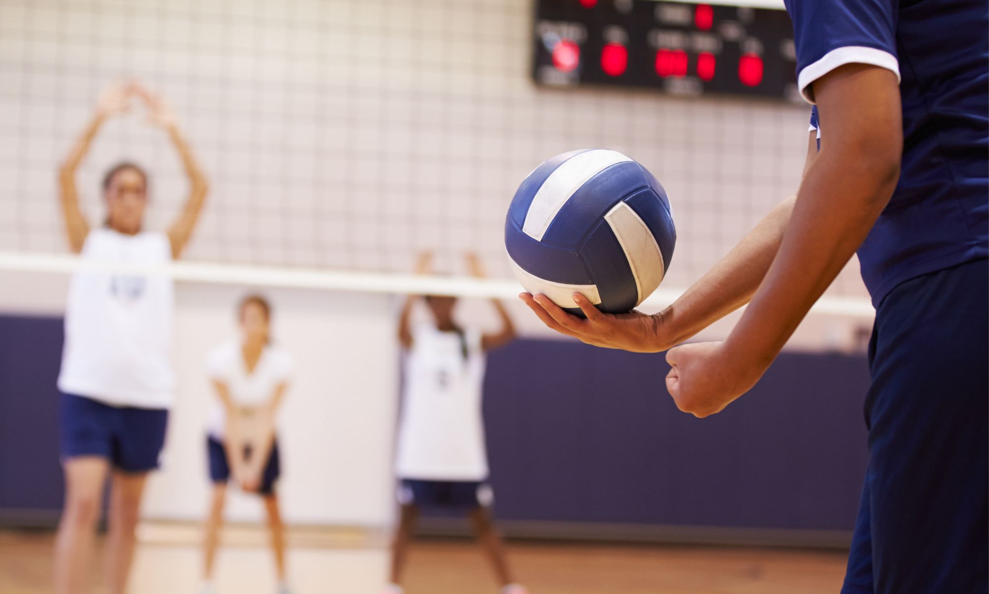 Someone holding a volleyball.