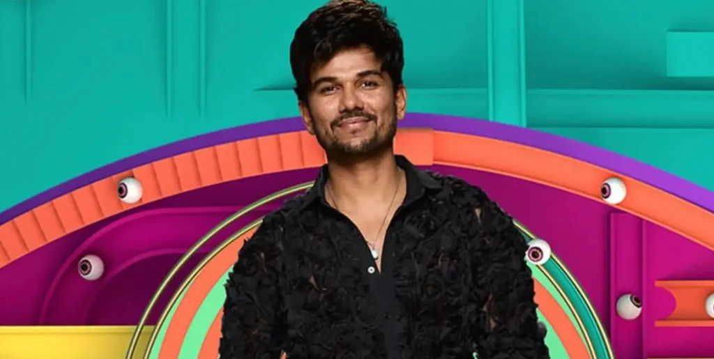 Big Brother housemate Gani in his promo image wearing a black shirt and smiling.