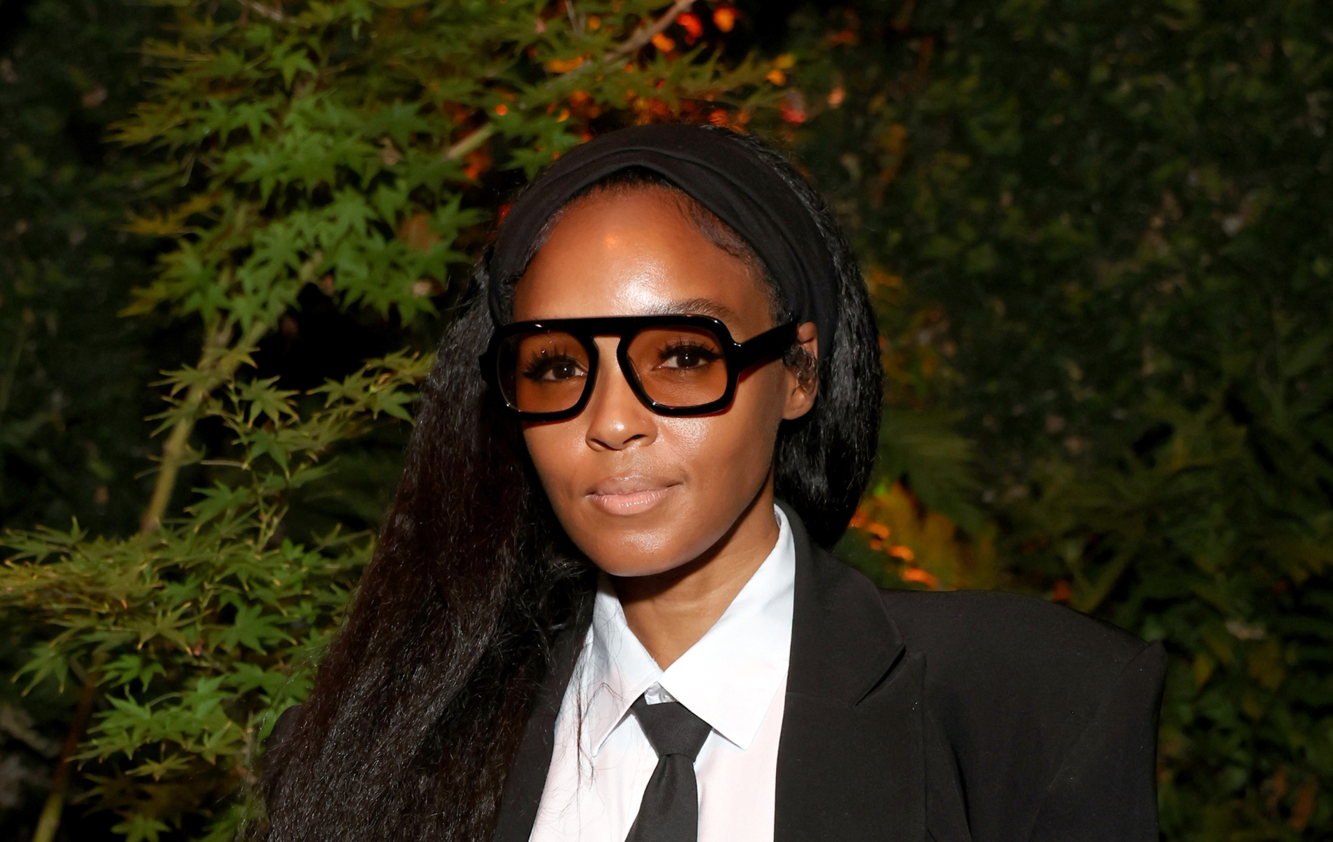 Janelle Monáe in a black and white suit with her hair down.