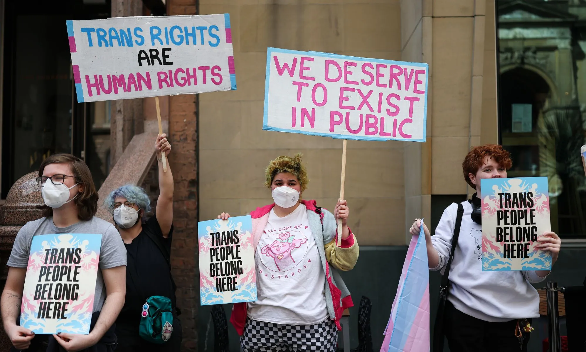 Activists holding signs during a protest.