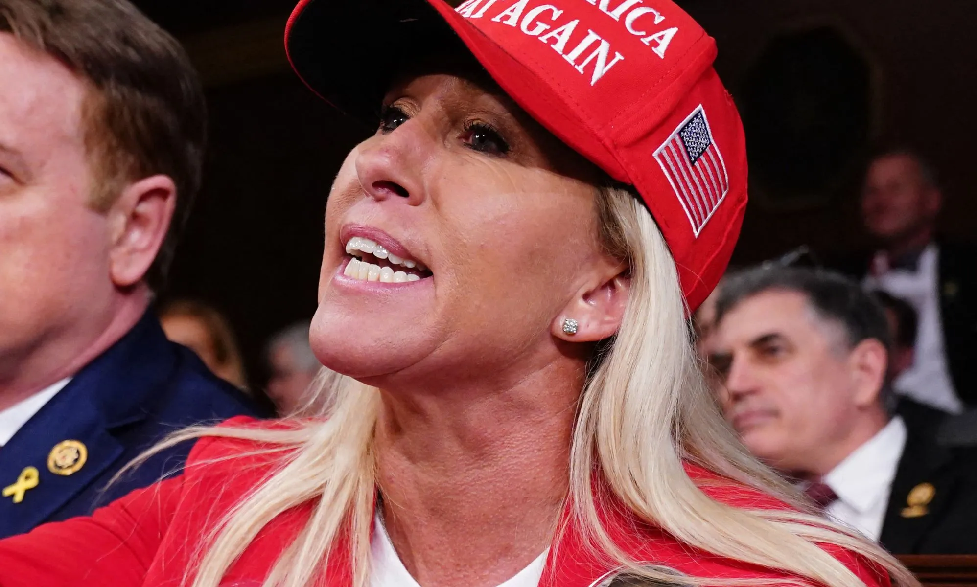 Marjorie Taylor Greene, pictured wearing a MAGA hat.