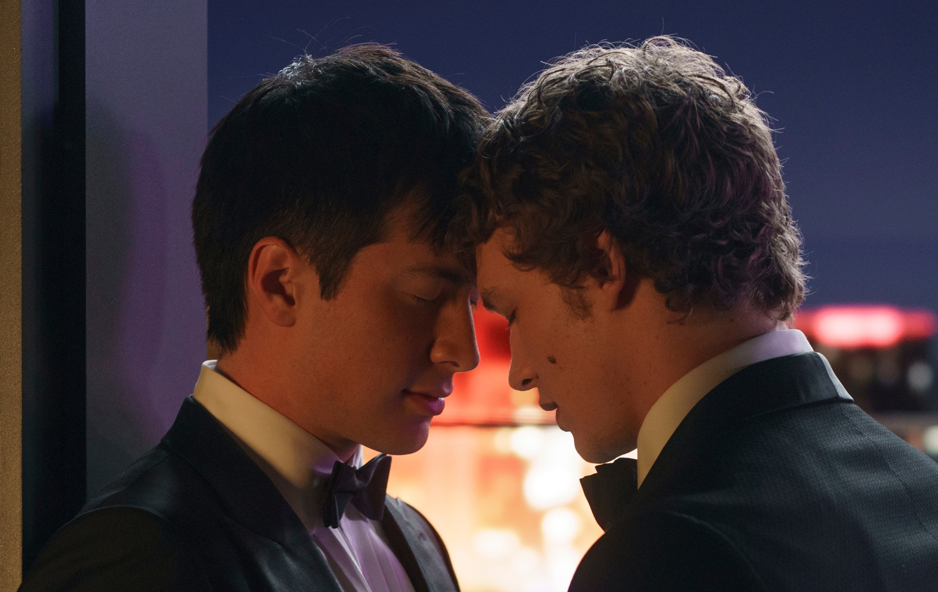 Heated Rivalry still: Shane (Tracker actor Hudson Williams) and Ilya (Joker: Folie à Deux star Connor Storie) resting their heads together, both wearing suits
