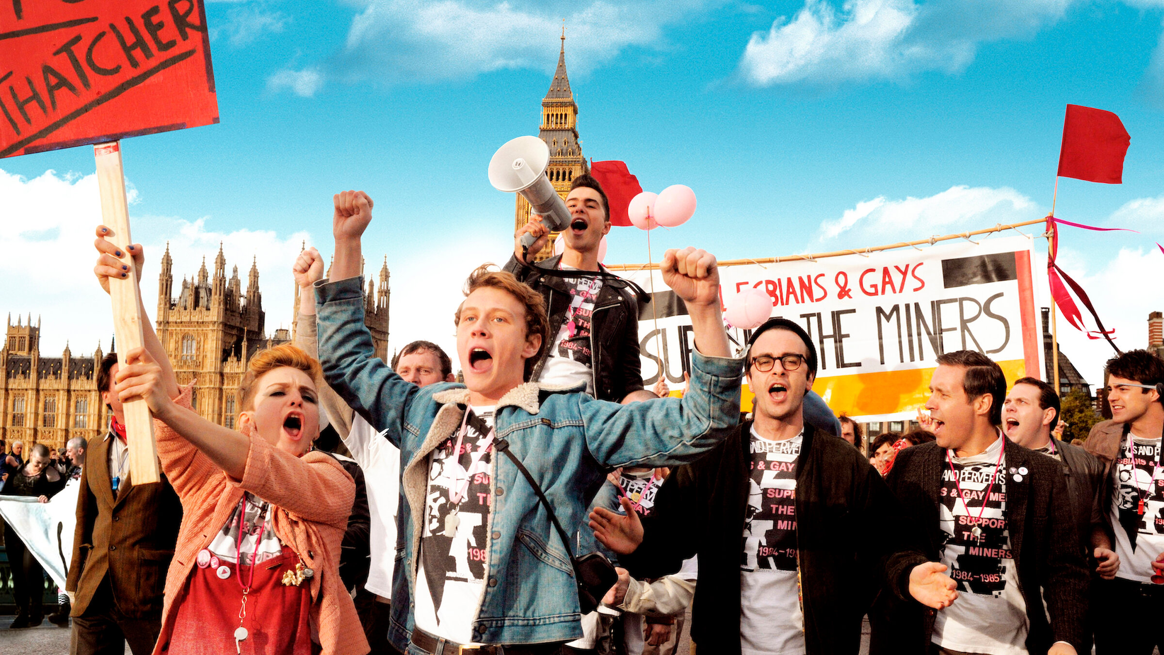 Image shows group of people protesting in support of the miners - waving placards