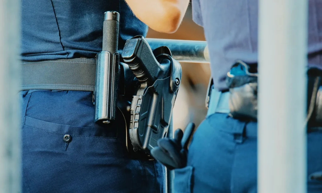 The waist of a police officer, which has a gun attached.