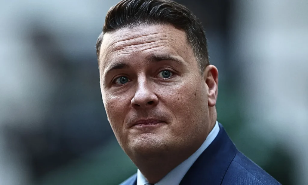 A close-up of Wes Streeting as he walks by.