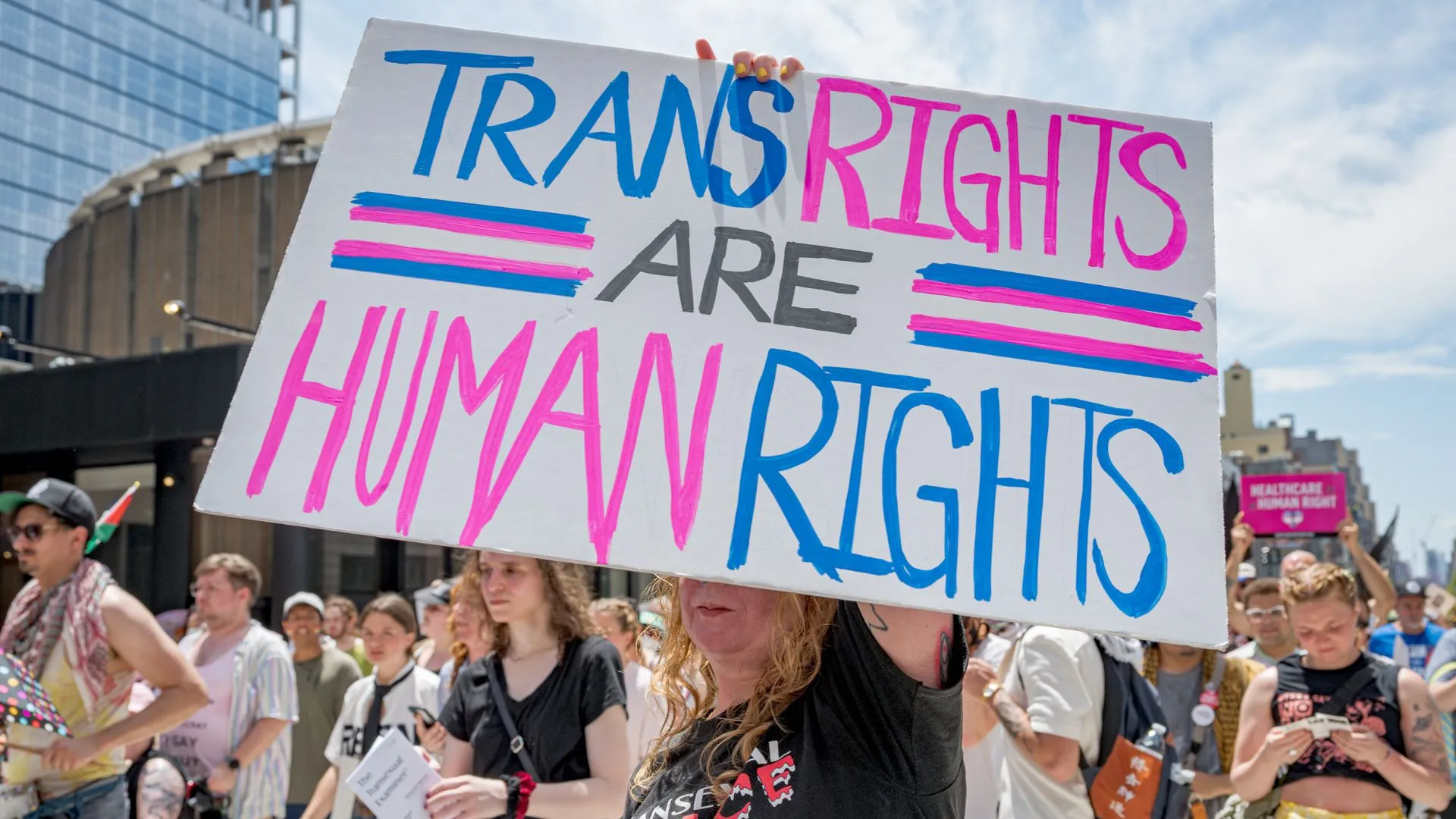 Protester holds up a sign that reads "trans rights are human rights"