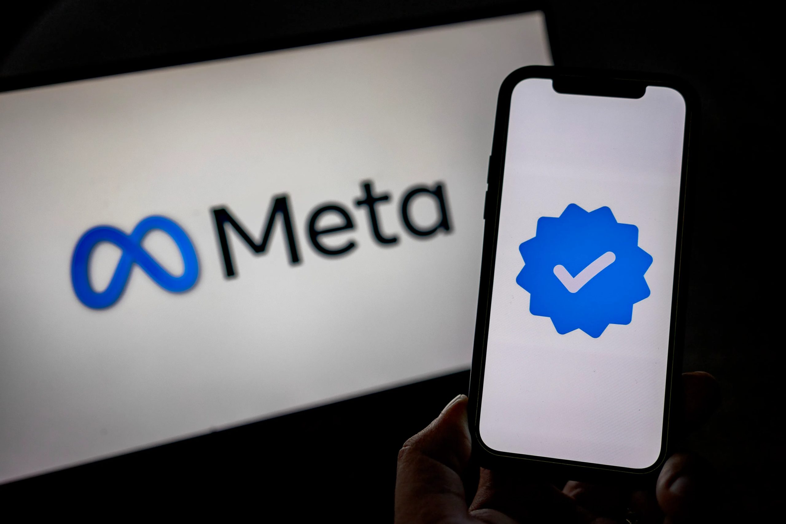 SANTA ROSA, PHILIPPINES - JANUARY 08: In this photo illustration, the Meta logo and its verified logo are seen on screens on January 08, 2025 in Santa Rosa, Philippines. Meta has announced the discontinuation of its fact-checking program, transitioning to a community-driven model that relies on users to add context to potentially misleading posts, a move aimed at promoting free expression. This significant policy shift has raised concerns among experts about the potential increase in misinformation and hate speech on Meta