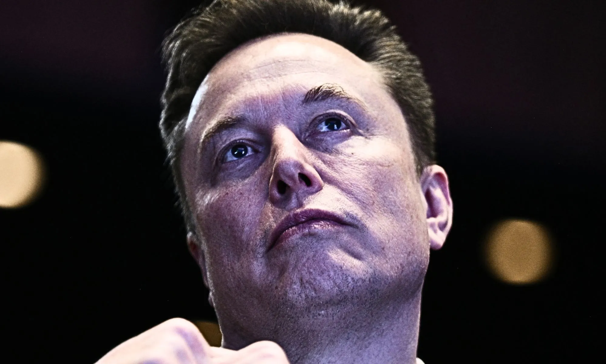 A shot of Elon Musk looking upward.